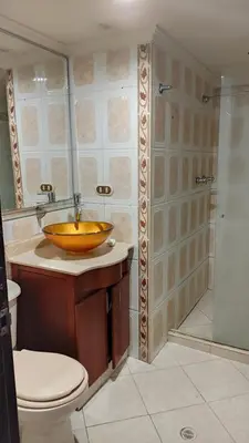 a bathroom with a wooden sink and a shower at Cápsula Urbana Central #4 in Medellín