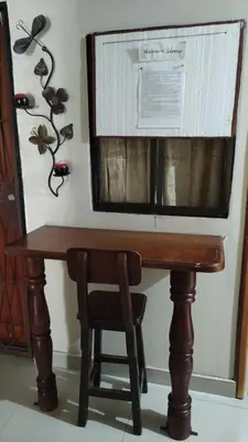 a wooden table with a chair and a microwave at Cápsula Urbana Central #4 in Medellín