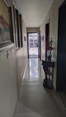 a hallway with a table and a door in a building at Cápsula Urbana Central #4 in Medellín