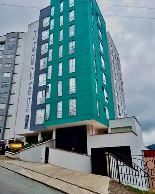 a green building on a city street at Acogedor apto 2 habitaciones in Manizales