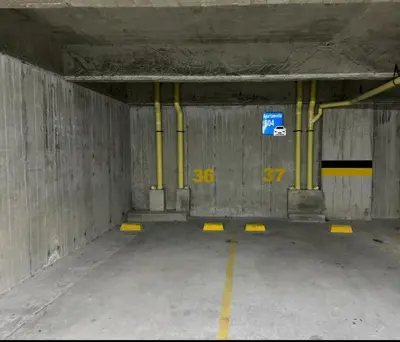 an empty parking garage with yellow piping in it at Acogedor apto 2 habitaciones in Manizales