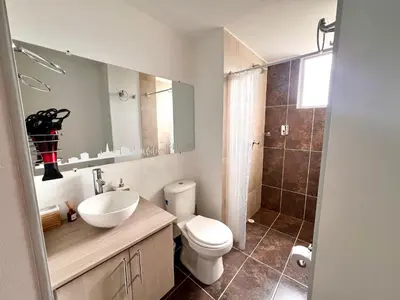 a bathroom with a toilet and a sink and a shower at Acogedor apto 2 habitaciones in Manizales