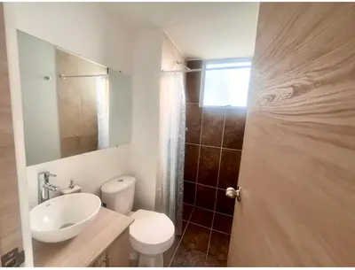 a bathroom with a sink and a toilet and a mirror at Acogedor apto 2 habitaciones in Manizales