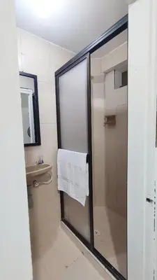 a bathroom with a shower with a white towel at Habitación, con baño privado #7 in Medellín