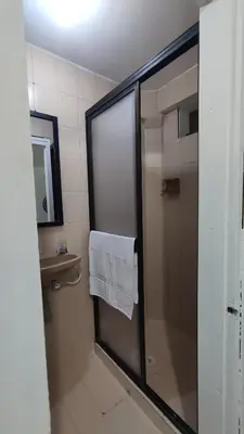 a bathroom with a shower with a white towel at Habitación, con baño privado #7 in Medellín