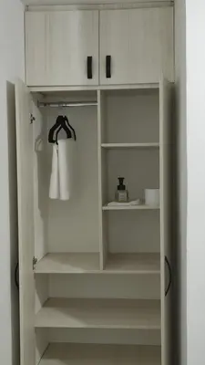 a closet with white cabinets and a white towel at Habitación, con baño privado #7 in Medellín