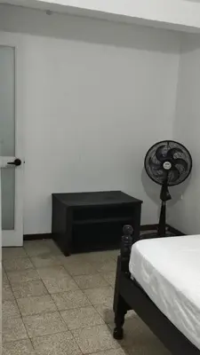 a bedroom with a bed and a black desk at Habitación, con baño privado #7 in Medellín