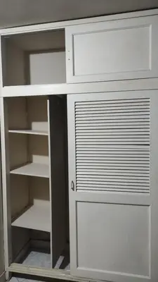 a white cabinet with a door and shelves at Hab. Cama doble y baño privado #3 in Medellín