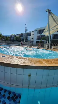 a large swimming pool with blue water in a building at Apartasol Santa Fe de Antioquia - Ciudadela Santa Fe in Santa Fe de Antioquia