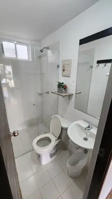 a white bathroom with a toilet and a sink at Apartasol Santa Fe de Antioquia - Ciudadela Santa Fe in Santa Fe de Antioquia
