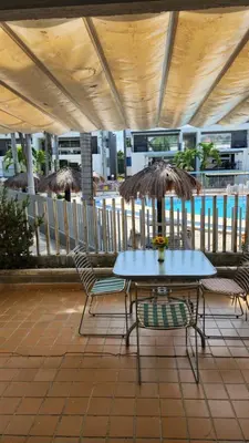a blue table and chairs on a patio at Apartasol Santa Fe de Antioquia - Ciudadela Santa Fe in Santa Fe de Antioquia