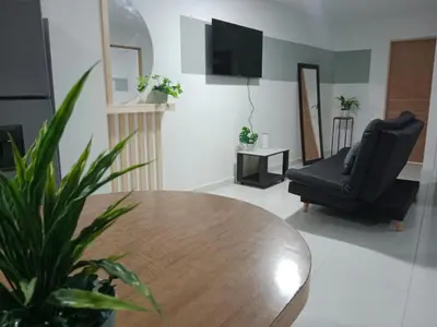 a living room with a table and a black chair at Hermoso e iluminado apartamento. in Itagüí