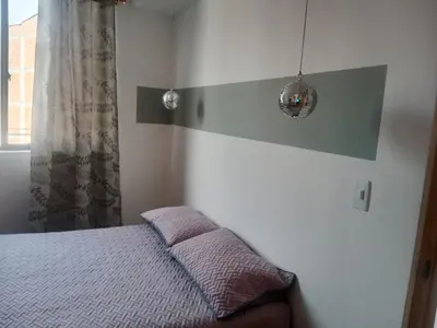 a small bedroom with a bed and a window at Hermoso e iluminado apartamento. in Itagüí