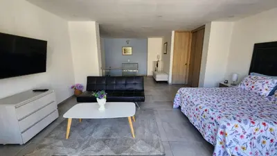 a bedroom with a bed and a couch and a table at Apartamentos Borbon Suites in Medellín