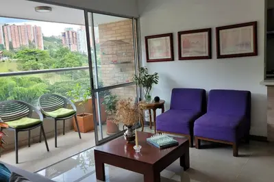 a living room with two purple chairs and a table at Estándar Suite en Sabaneta in Sabaneta