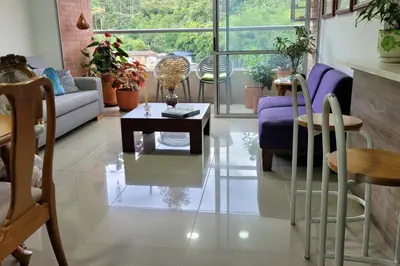 a living room with a couch and a table at Estándar Suite en Sabaneta in Sabaneta