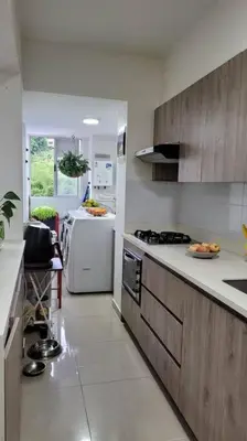 a kitchen with a stove and a refrigerator at Estándar Suite en Sabaneta in Sabaneta