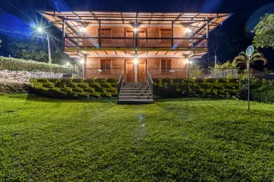 a house with stairs leading up to it at night at HOTEL EMBRUJO CAMPESTRE in Jardin