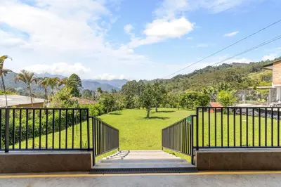 a gate with a view of a park at HOTEL EMBRUJO CAMPESTRE in Jardin