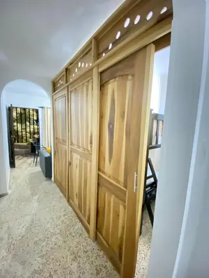 a hallway with wooden doors in a house at Hermoso apartamento en zona central de Medellín in Medellín