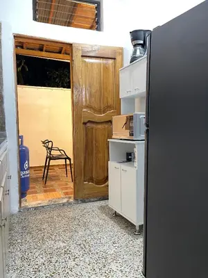 a kitchen with a black refrigerator and a door at Hermoso apartamento en zona central de Medellín in Medellín