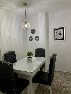a white table with chairs and a potted plant on it at Hermoso apartamento en zona central de Medellín in Medellín