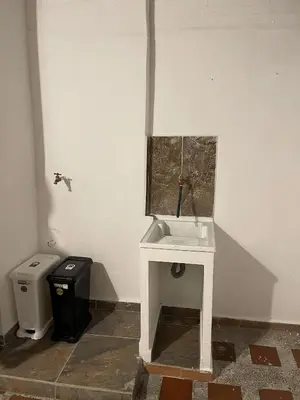 a bathroom with a white sink and a trash can at Hermoso apartamento en zona central de Medellín in Medellín