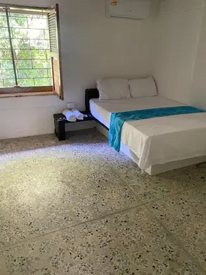 a bedroom with a bed and a window at Mirador del Magdalena in Doradal
