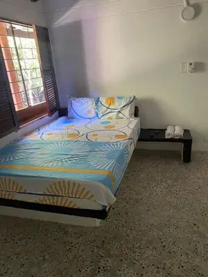 a bedroom with a bed and a window at Mirador del Magdalena in Doradal