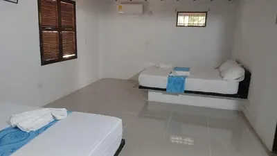 a room with two beds and a window in it at Mirador del Magdalena in Doradal