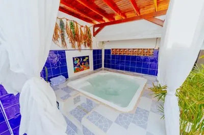 a bath tub in a room with a blue tiled floor at Selva María Hotel Boutique in Santa Fe de Antioquia