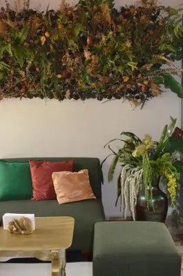 a living room with a green couch and a table at Selva María Hotel Boutique in Santa Fe de Antioquia