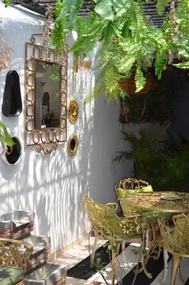 a mirror on a wall with chairs and a table at Selva María Hotel Boutique in Santa Fe de Antioquia