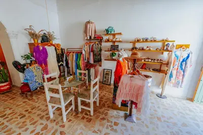 a clothing store with racks of clothes on shelves at Selva María Hotel Boutique in Santa Fe de Antioquia