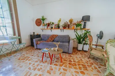 a living room with a couch and a table at Selva María Hotel Boutique in Santa Fe de Antioquia