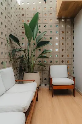 a room with two chairs and a potted plant at Poblado Muuk Hotel Boutique Campestre in Medellín