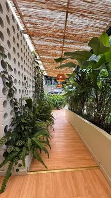a hallway with plants in a building with a ceiling at Poblado Muuk Hotel Boutique Campestre in Medellín