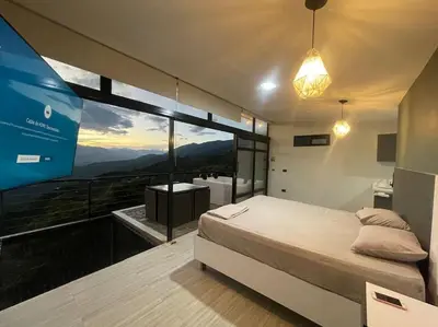 a bedroom with a bed and a large window at Cabaña en Sopetran con jacuzzi in Sopetran