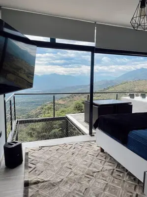 a bedroom with a bed and a view of the mountains at Cabaña en Sopetran con jacuzzi in Sopetran