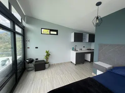 a bedroom with a bed and a desk in it at Cabaña en Sopetran con jacuzzi in Sopetran
