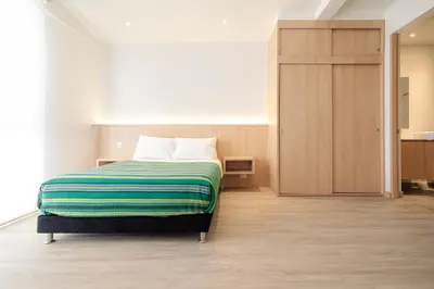 a bedroom with a bed and a closet in it at Hotel Estar in Manizales