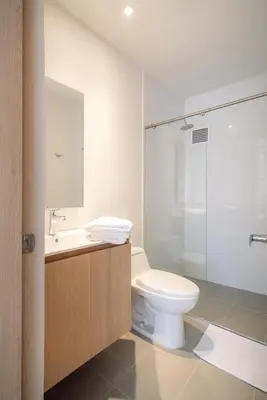 a bathroom with a toilet and a glass shower at Hotel Estar in Manizales