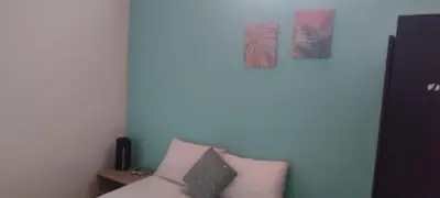 a room with a couch and two pictures on the wall at cabaña 83 Santorini in Puerto Triunfo