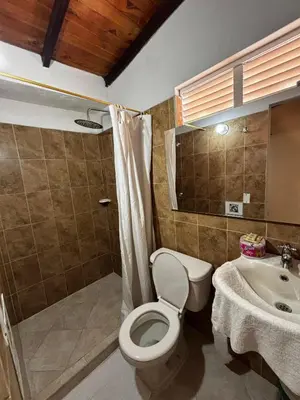 a bathroom with a toilet and a sink at cabaña 83 Santorini in Puerto Triunfo
