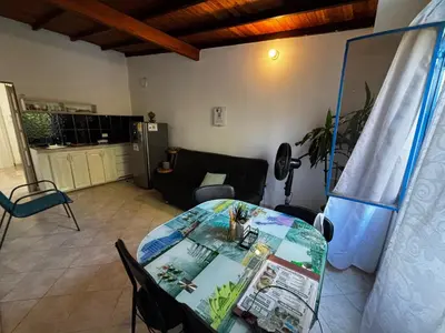 a living room with a table and a couch at cabaña 83 Santorini in Puerto Triunfo