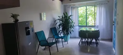 a room with a table and chairs and a window at cabaña 83 Santorini in Puerto Triunfo