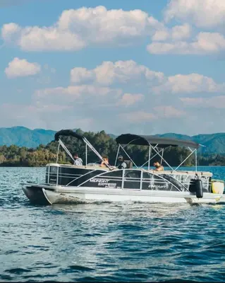 a group of people in a boat on the water at The Brown, Guatape, Autograph Collection in Guatapé