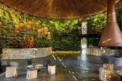 a lobby with a large wall of green plants at The Brown, Guatape, Autograph Collection in Guatapé
