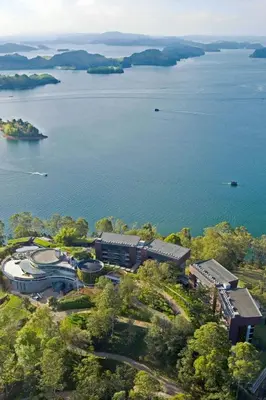 an aerial view of a train station next to a body of water at The Brown, Guatape, Autograph Collection in Guatapé