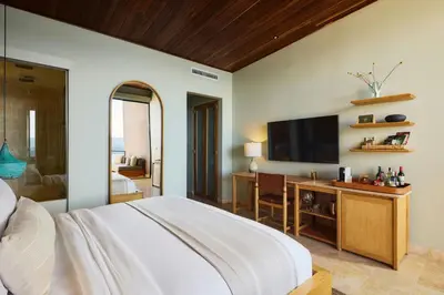 a bedroom with a large bed and a television at The Brown, Guatape, Autograph Collection in Guatapé